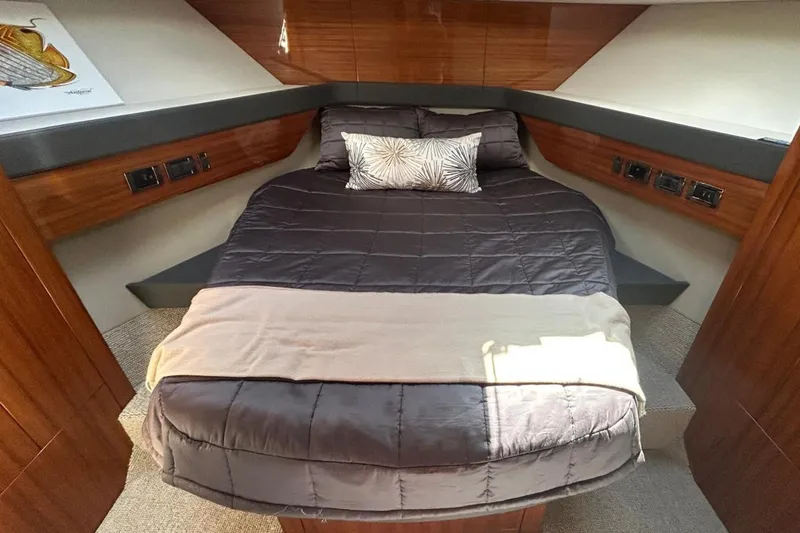  Yacht Photos Pics Luxurious bedroom interior of 2020 Maritimo M64 yacht with elegant bedding and wood paneling.