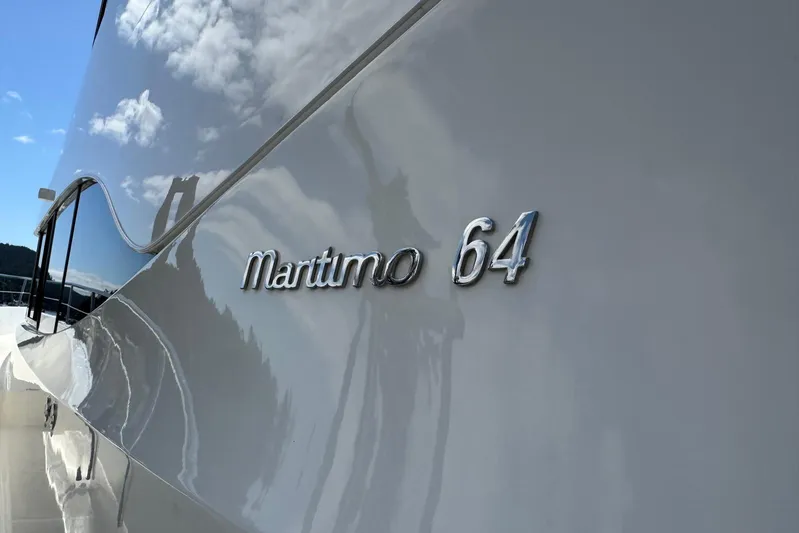  Yacht Photos Pics 2020 Maritimo M64 yacht exterior with reflective surface and logo.