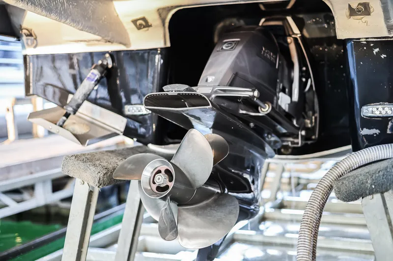 Tarini Yacht Photos Pics 2020 Regal 28 Express boat propeller and stern drive in maintenance setting.