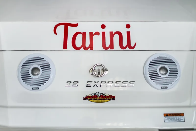Tarini Yacht Photos Pics Rear view of 2020 Regal 28 Express boat with speakers and "Tarini" name.
