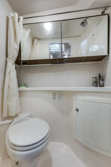 Tarini Yacht Photos Pics 2020 Regal 28 Express boat bathroom with toilet, mirror, and sink.