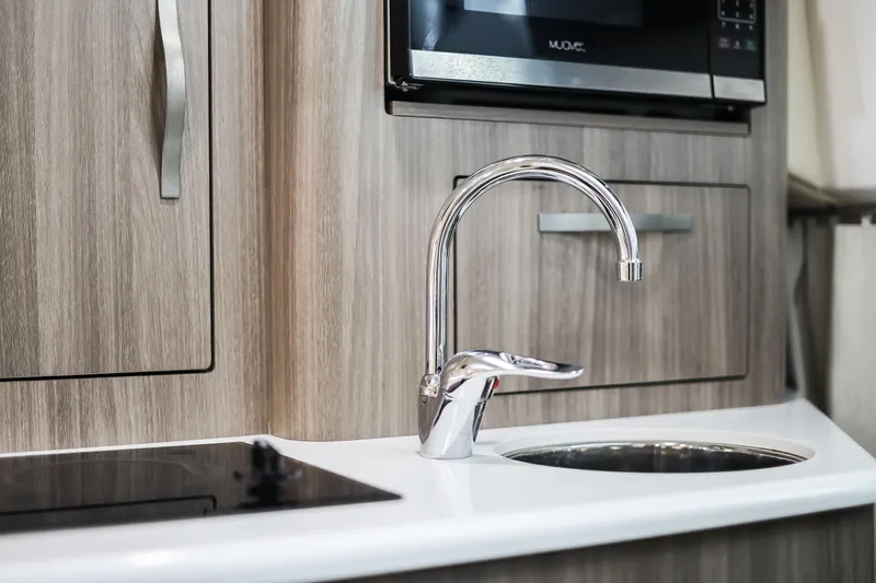 Tarini Yacht Photos Pics Modern kitchen area in 2020 Regal 28 Express boat with sleek faucet and appliances.