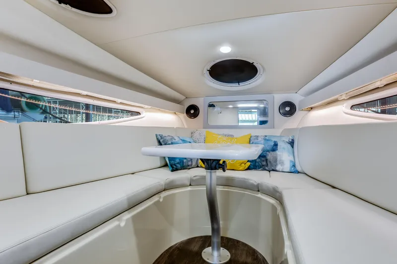 Tarini Yacht Photos Pics 2020 Regal 28 Express boat interior with white seating and decorative pillows.