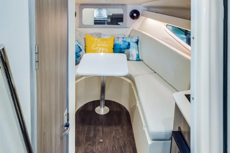 Tarini Yacht Photos Pics 2020 Regal 28 Express cabin interior with cozy seating and decorative pillows.