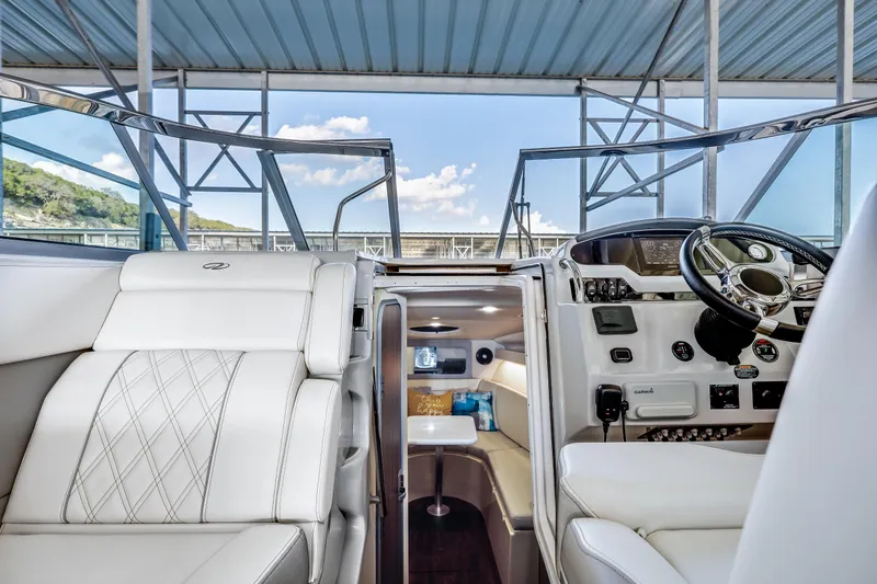 Tarini Yacht Photos Pics 2020 Regal 28 Express boat interior with white seating and modern dashboard.