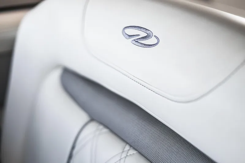 Tarini Yacht Photos Pics 2020 Regal 28 Express boat seat with embroidered logo, white and gray upholstery.