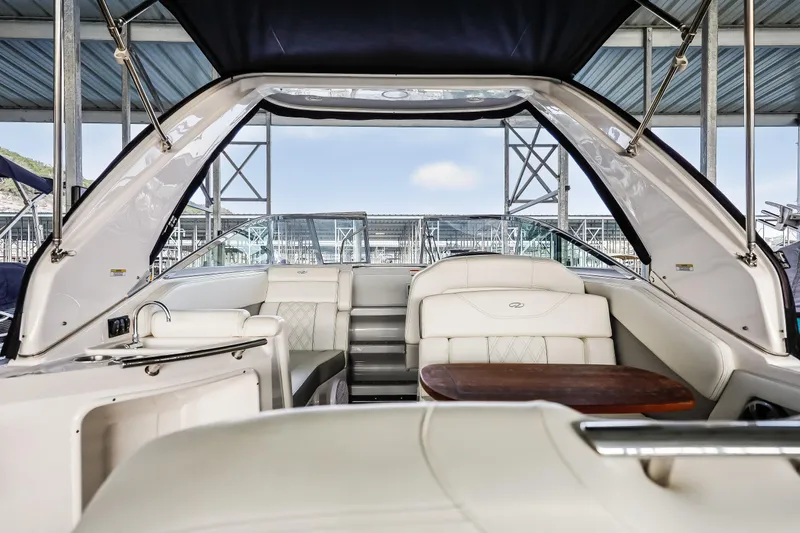 Tarini Yacht Photos Pics 2020 Regal 28 Express boat interior with white seating and wooden table.