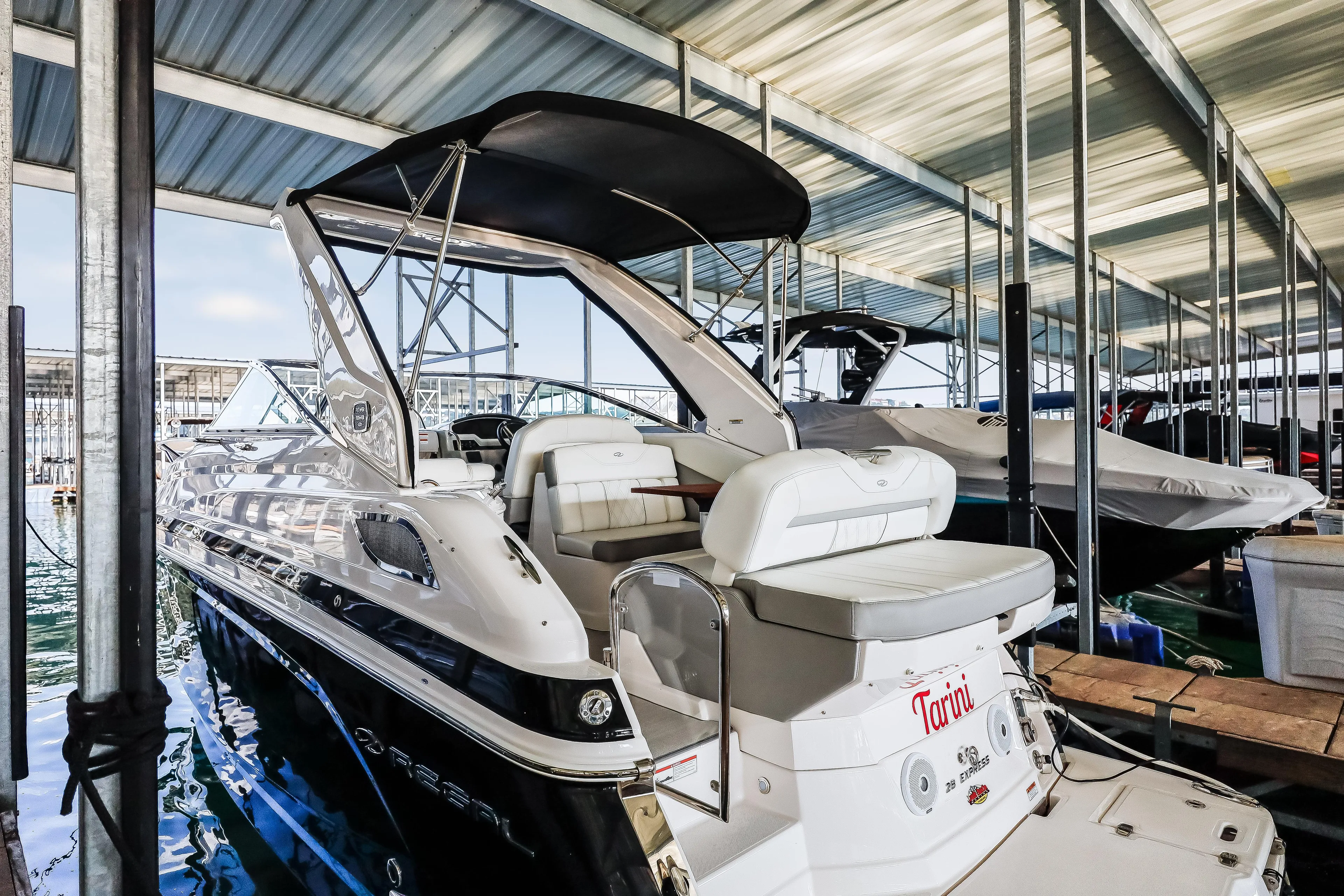 Tarini Yacht Photos Pics 2020 Regal 28 Express boat docked in a covered marina.