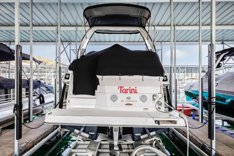 Tarini Yacht Photos Pics 2020 Regal 28 Express boat docked in a covered marina.