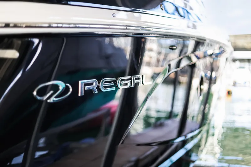 Tarini Yacht Photos Pics 2020 Regal 28 Express boat with sleek black exterior and logo.