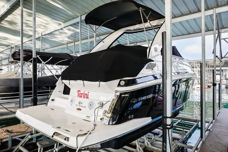 Tarini Yacht Photos Pics 2020 Regal 28 Express boat docked in a covered marina.