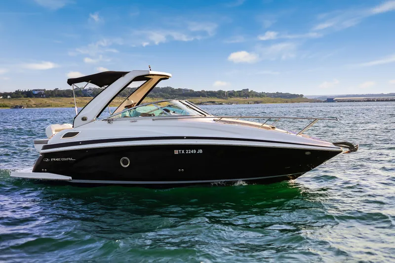 Tarini Yacht Photos Pics 2020 Regal 28 Express boat cruising on a sunny day with scenic shoreline.