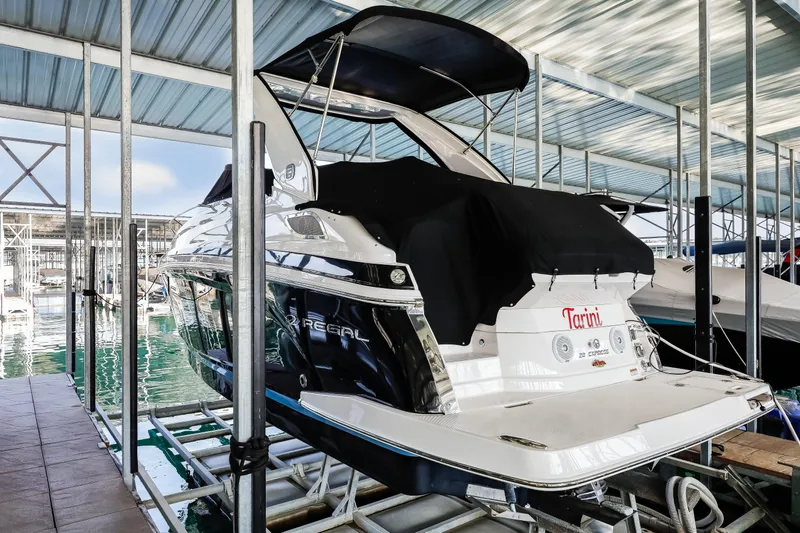 Tarini Yacht Photos Pics 2020 Regal 28 Express boat docked in a covered marina.