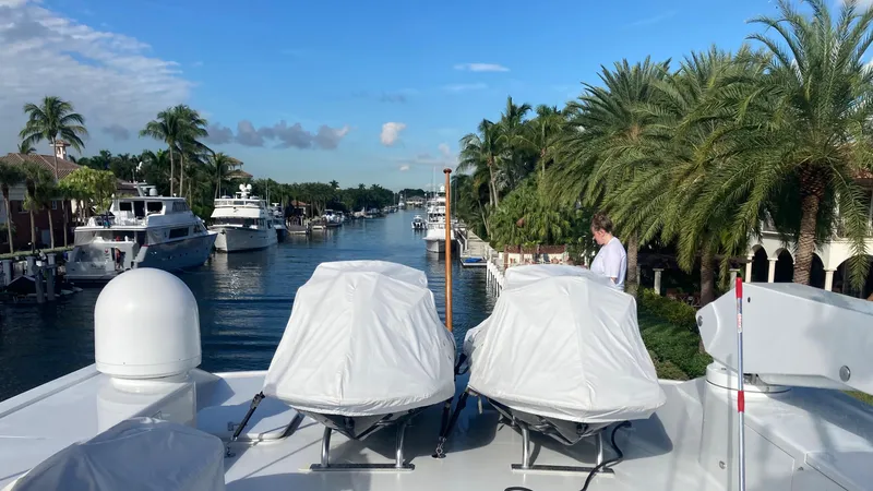 Silver Seas Yacht Photos Pics Luxury yacht docked in a scenic canal, surrounded by palm trees and other boats.