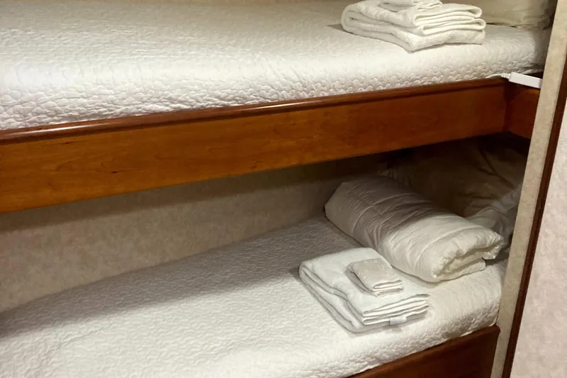 Silver Seas Yacht Photos Pics Bunk beds with white linens and towels in a 1998 Burger Raised Pilothouse yacht.
