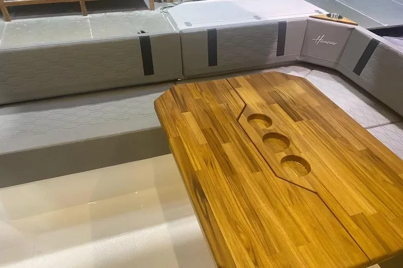  Yacht Photos Pics Luxurious interior of 2026 Hanover 387 Tuxedo, featuring elegant wood table and plush seating.