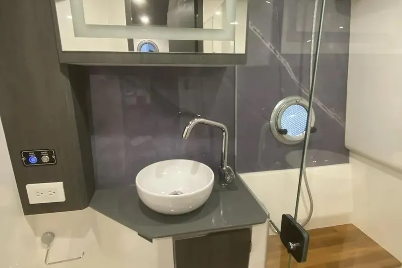  Yacht Photos Pics Luxurious bathroom interior of 2026 Hanover 387 Tuxedo Luxury Edition with modern sink and fixtures.