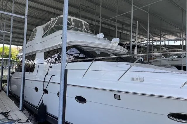 Flying Lady Yacht Photos Pics 2004 Carver 570 Voyager Pilothouse yacht docked in a covered marina.