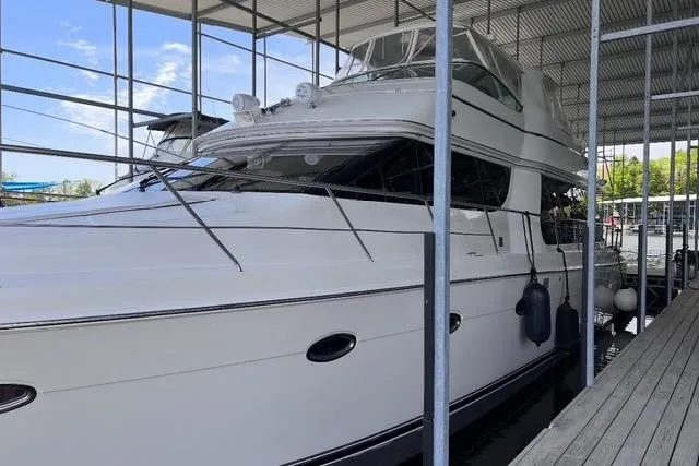 Flying Lady Yacht Photos Pics 2004 Carver 570 Voyager Pilothouse yacht docked in a covered marina.