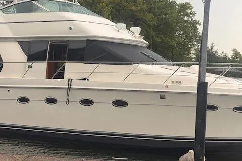 Flying Lady Yacht Photos Pics 2004 Carver 570 Voyager Pilothouse yacht docked by the shore.