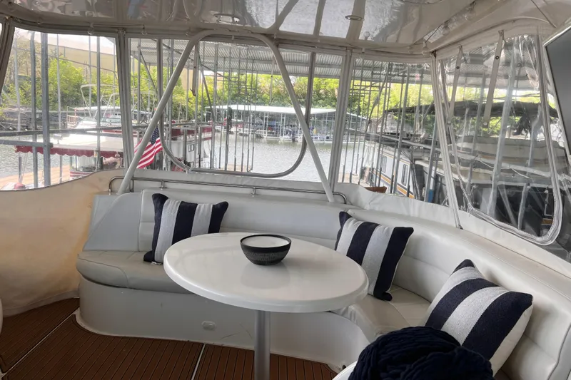 Flying Lady Yacht Photos Pics Luxurious 2004 Carver 570 Voyager Pilothouse yacht interior with seating and table.