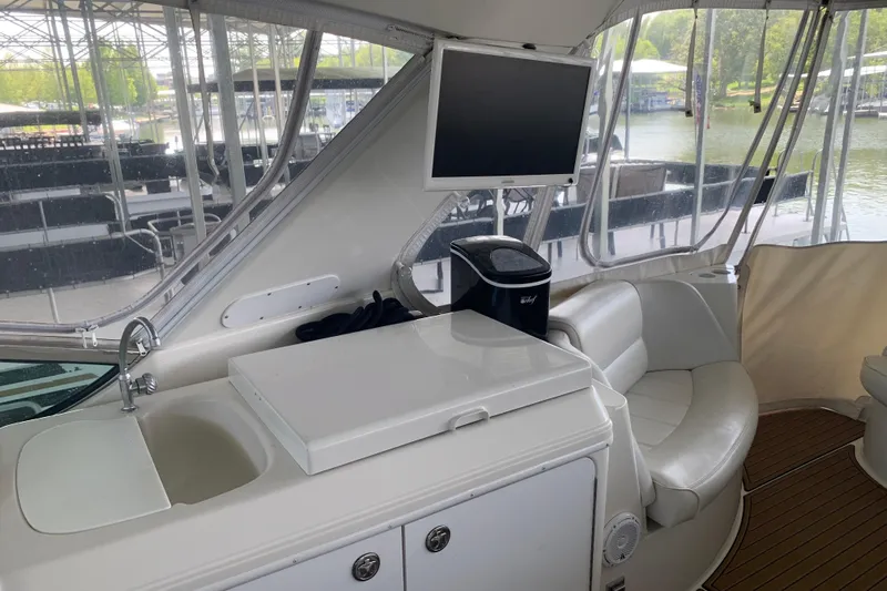 Flying Lady Yacht Photos Pics Interior of 2004 Carver 570 Voyager Pilothouse with seating, sink, and TV.