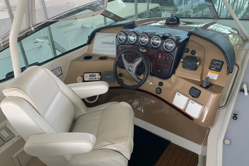 Flying Lady Yacht Photos Pics Pilothouse interior of 2004 Carver 570 Voyager with steering wheel and navigation instruments.
