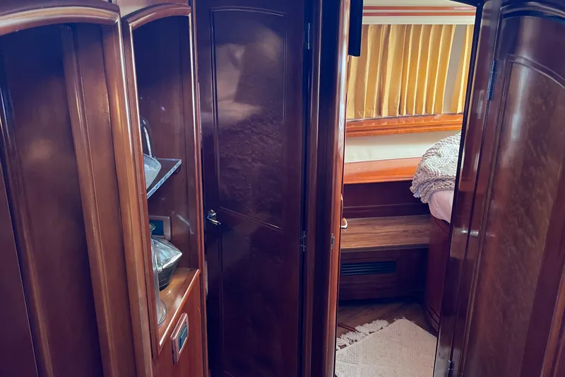 Flying Lady Yacht Photos Pics Luxurious interior of 2004 Carver 570 Voyager Pilothouse with wood cabinetry and cozy bedroom.