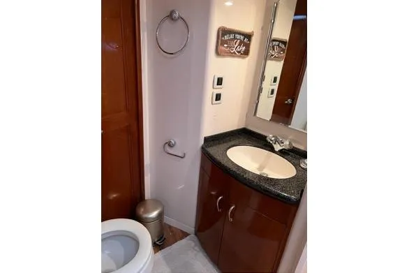 Flying Lady Yacht Photos Pics Bathroom interior of 2004 Carver 570 Voyager Pilothouse with sink and toilet.