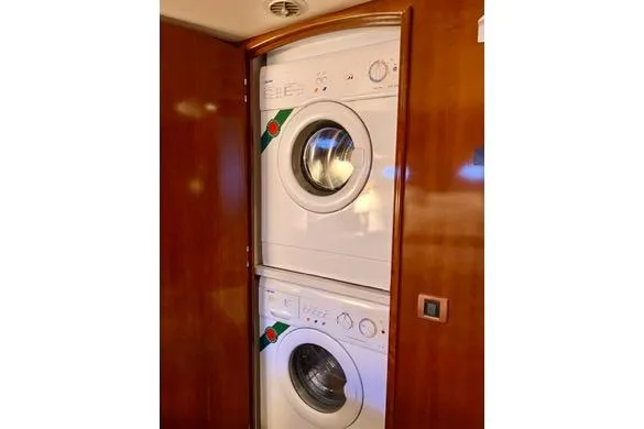 Flying Lady Yacht Photos Pics Stacked washer and dryer in 2004 Carver 570 Voyager Pilothouse yacht interior.