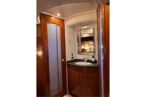 Flying Lady Yacht Photos Pics 2004 Carver 570 Voyager Pilothouse bathroom with wood cabinetry and modern sink.
