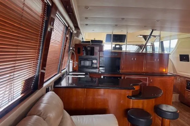 Flying Lady Yacht Photos Pics Luxurious interior of 2004 Carver 570 Voyager Pilothouse with modern kitchen and seating area.