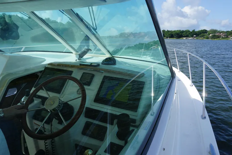 The Pearl Yacht Photos Pics 2007 Tiara Yachts 3900 helm with navigation equipment, steering wheel, and water view.