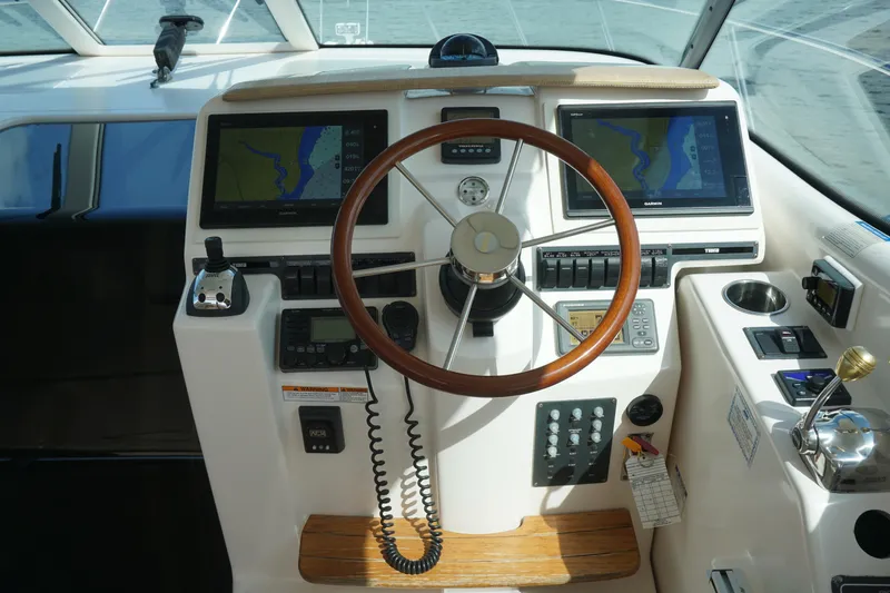 The Pearl Yacht Photos Pics 2007 Tiara Yachts 3900 helm with dual navigation screens and wooden steering wheel.