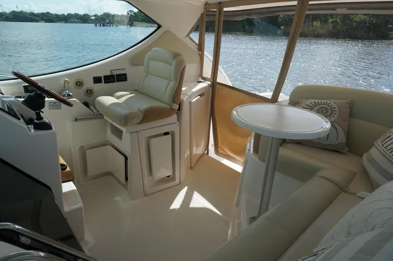 The Pearl Yacht Photos Pics Interior of 2007 Tiara Yachts 3900, featuring helm and seating area with water view.