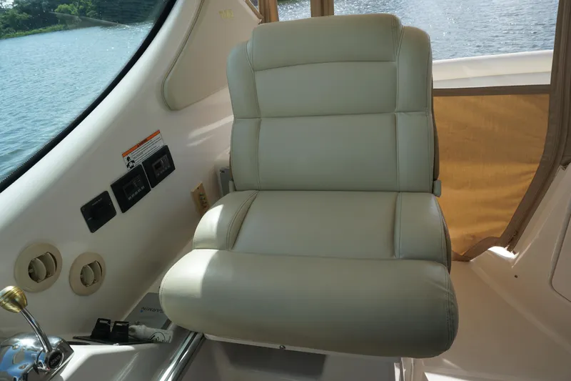 The Pearl Yacht Photos Pics Captain's chair on 2007 Tiara Yachts 3900, featuring beige upholstery and control panel.
