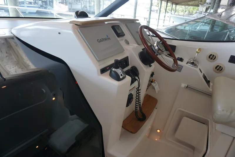 The Pearl Yacht Photos Pics 2007 Tiara Yachts 3900 helm with Garmin navigation and wooden steering wheel.
