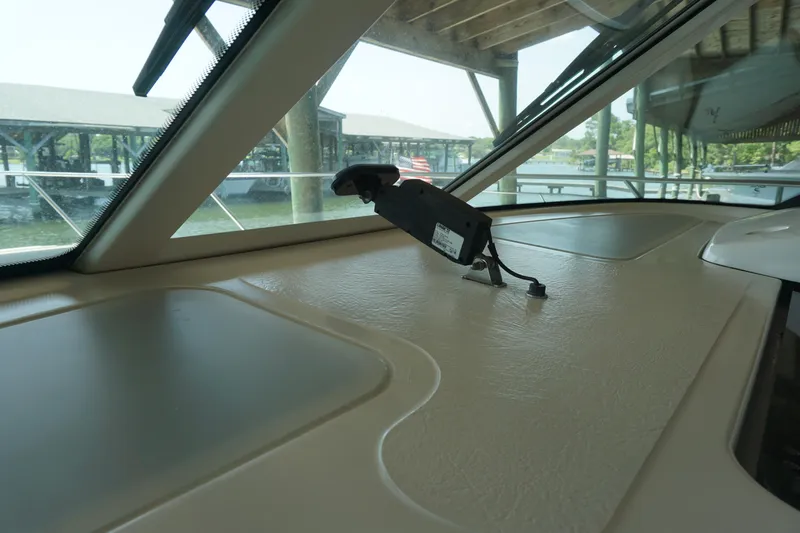 The Pearl Yacht Photos Pics 2007 Tiara Yachts 3900 dashboard with navigation equipment, docked under a covered marina.