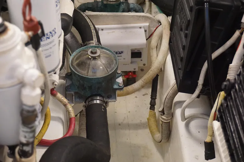 The Pearl Yacht Photos Pics Engine compartment of 2007 Tiara Yachts 3900, showcasing hoses and mechanical components.