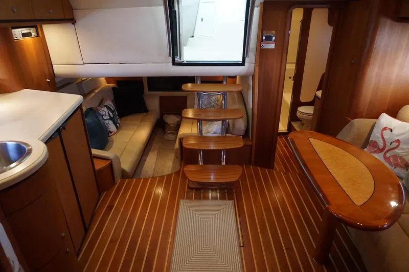 The Pearl Yacht Photos Pics Interior of 2007 Tiara Yachts 3900, featuring wooden flooring and cozy seating area.