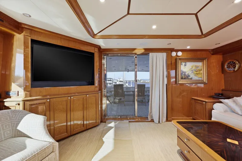Footloose Yacht Photos Pics Luxurious interior of 2008 Cheoy Lee 95 Motor Yacht with elegant wood paneling and large TV.