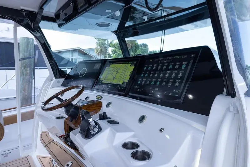 Next To Sell Yacht Photos Pics 2020 HCB Estrella boat cockpit with advanced navigation screens and wooden steering wheel.