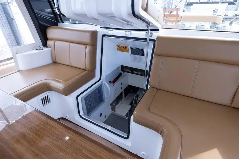 Next To Sell Yacht Photos Pics Interior of 2020 HCB Estrella boat with tan leather seating and storage compartment.