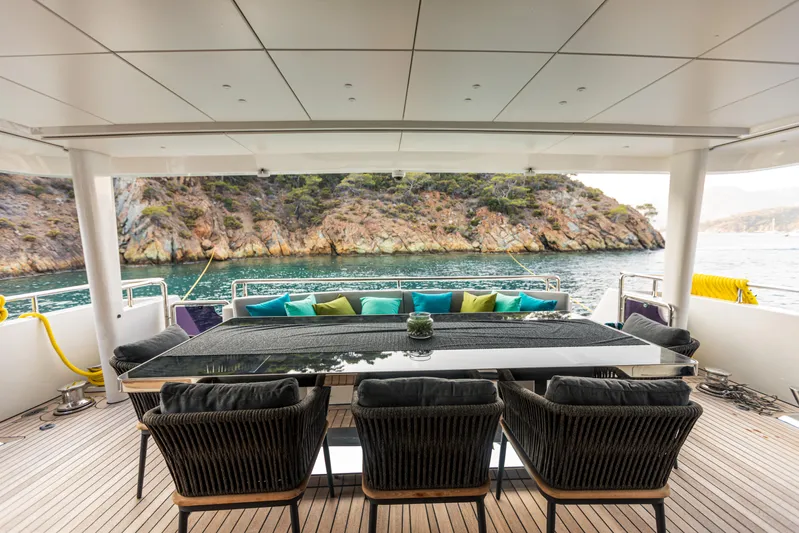 Zeemar Yacht Photos Pics Luxury yacht deck with dining area, colorful cushions, and scenic ocean view. Custom Aydos Yat Sanayi 100', 2016.
