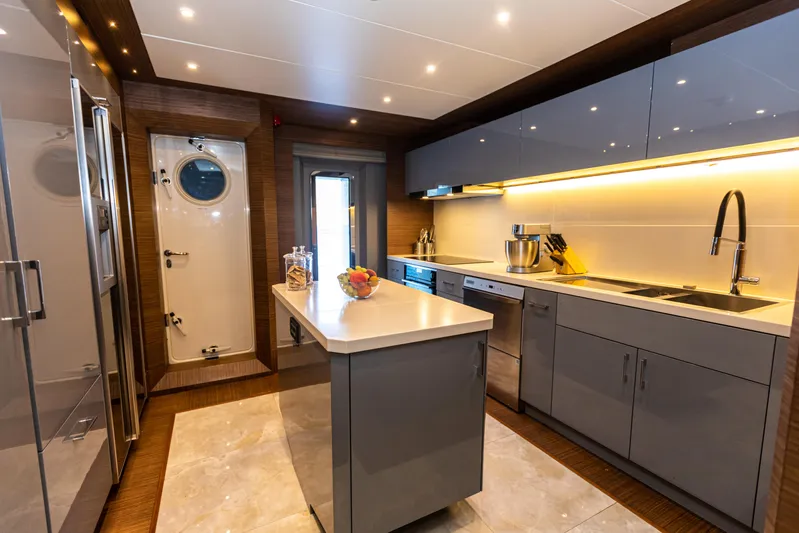 Zeemar Yacht Photos Pics Modern kitchen on a 2016 Custom Aydos Yat Sanayi 100' yacht with sleek cabinetry and island.