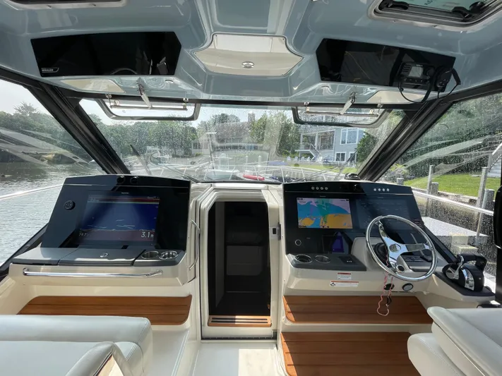 Sea Cure Yacht Photos Pics Helm of 2021 Boston Whaler 405 Conquest with advanced navigation displays and steering wheel.