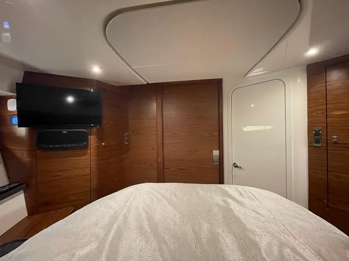 Sea Cure Yacht Photos Pics Luxurious cabin interior of 2021 Boston Whaler 405 Conquest with TV and wood paneling.