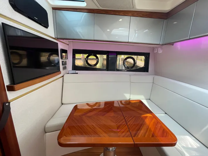 Sea Cure Yacht Photos Pics Interior of 2021 Boston Whaler 405 Conquest with white seating and wooden table.