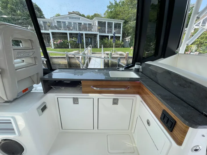 Sea Cure Yacht Photos Pics Interior of 2021 Boston Whaler 405 Conquest boat with sleek kitchen area and scenic view.
