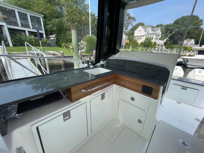 Sea Cure Yacht Photos Pics Interior view of 2021 Boston Whaler 405 Conquest boat, featuring sleek cabinetry and countertop.